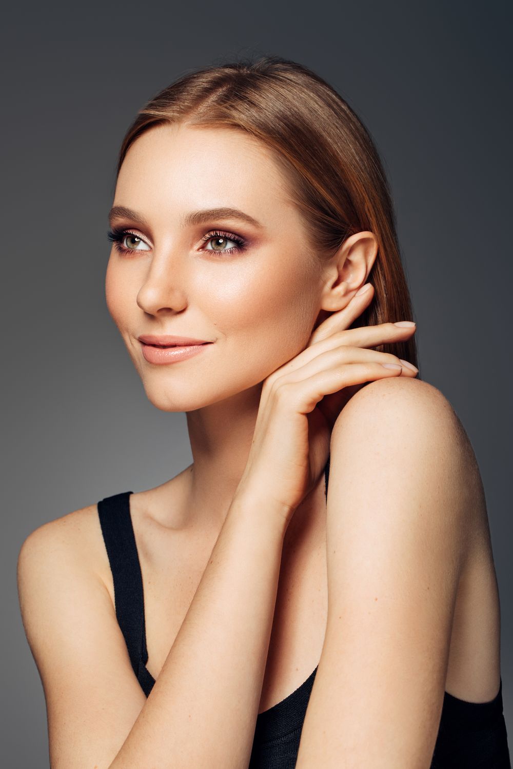Smiling woman with long hair in white shirt.